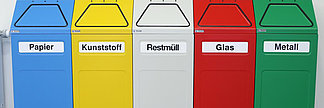 Coloured recycling bins marked with paper, plastic, glas, etc.
