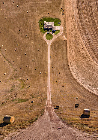 Photography of a farm with bales in an unusual perspective